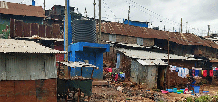 Standard settlement housing made of iron sheets and mud bricks by the river in Kibera.