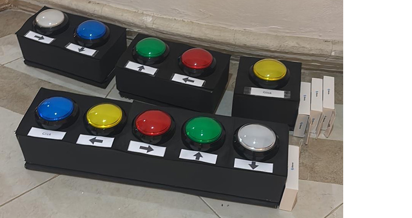 Small black boxes with large colorful buttons.
