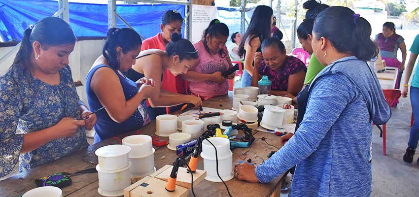 team assembling and soldering their waterproof fishing lanterns together