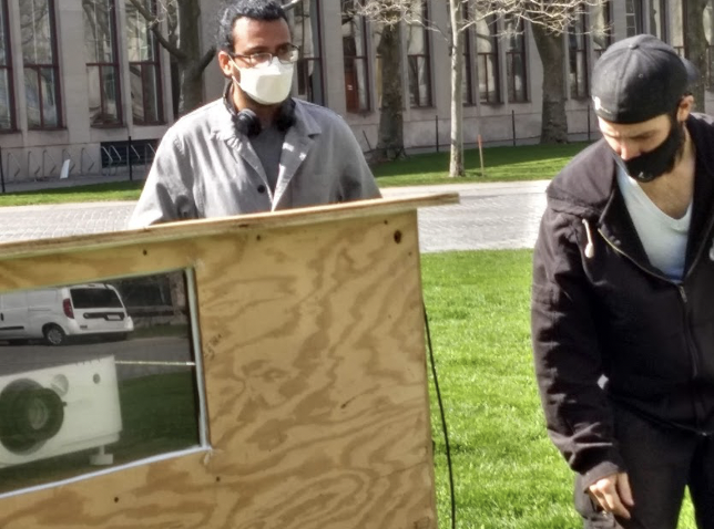 Gaurav Patekar, graduate student in the MIT Media Lab, and Robert Shea, MIT Audio Visual, setting up the projector in the projector box.