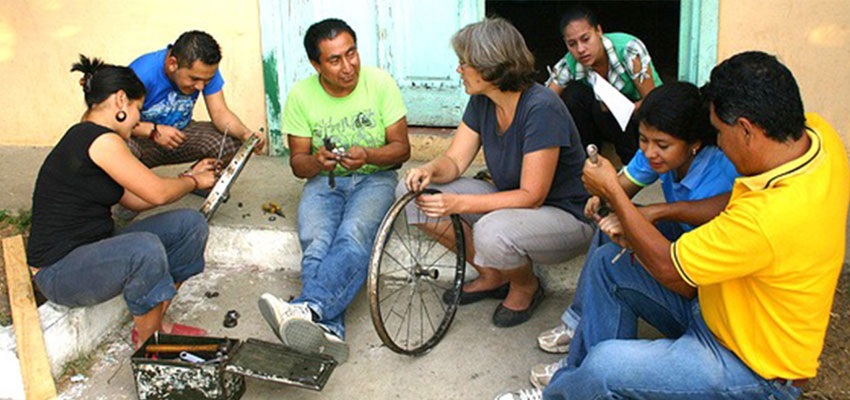 MIT D-Lab Founding Director Amy Smith (center) with inventor and Bici-Tec Founder Carlos Marroquin (third from left), working with members of a community in El Salvador. Photo: MIT D-Lab.