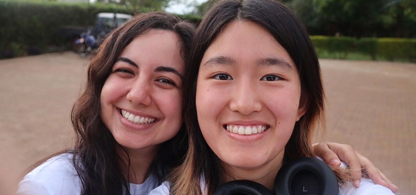Close up of two smiling women's faces.